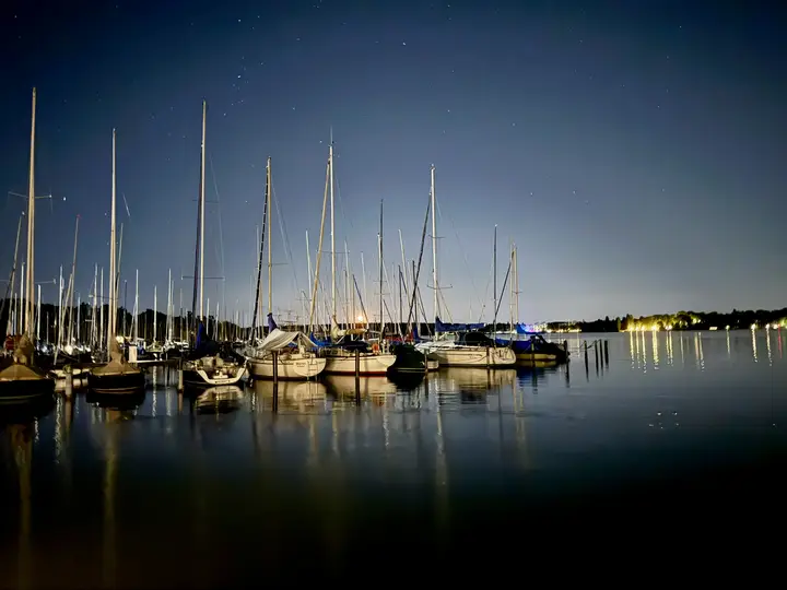 Segelboote im Hafen bei Nacht mit Sternenhimmel